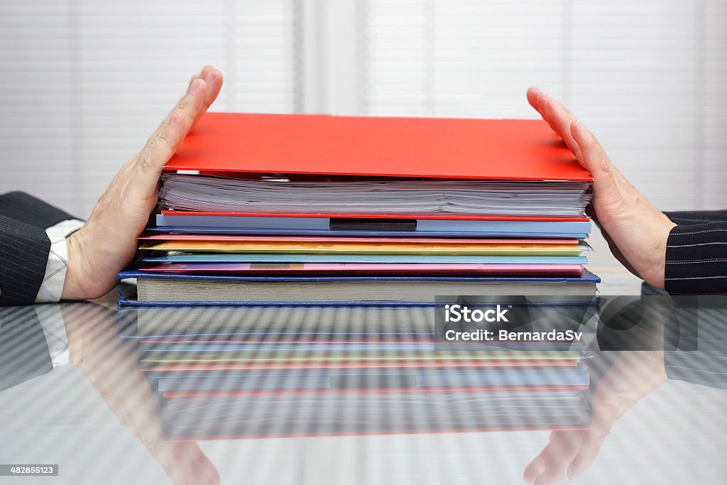 postpone work concept. Man and woman are pushing files postpone work concept. Man and woman are pushing files and folders to each other Civil Servant Stock Photo