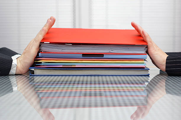 postpone work concept. Man and woman are pushing files postpone work concept. Man and woman are pushing files and folders to each other woman pushing tire stock pictures, royalty-free photos & images