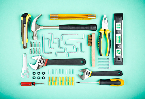 various of work tools in order on the green background