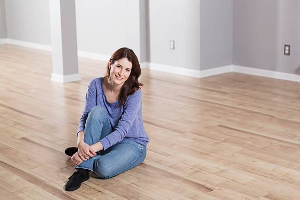 istock Woman sitting on wood floor 482857021