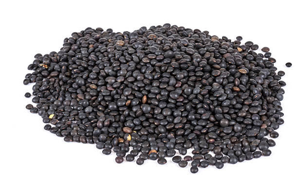 istock Heap of black lentil isolated on white 482857289