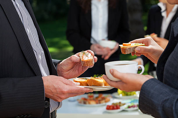 Business lunch in the garden Business people who are eating lunch in the garden coffee break stock pictures, royalty-free photos & images