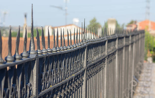 istock wrought iron fence in perspective 482857963