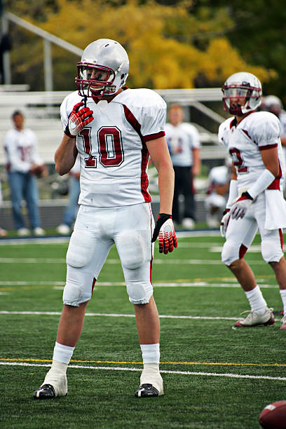 istock American Football Defensive Lineman and Defensive Back 482858555