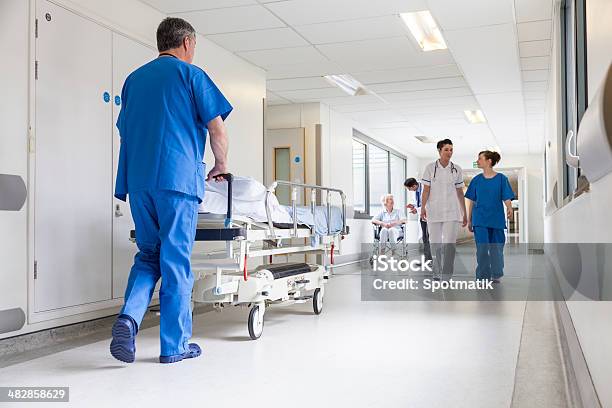 Doctors Hospital Corridor Nurse Pushing Gurney Stretcher Bed Stock Photo - Download Image Now