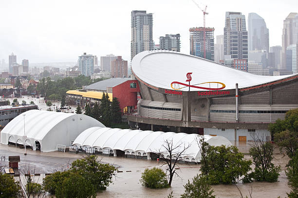 Calgary 2013 Flood Calgary, Canada - June 21, 2013: The historic 2013 Calgary Flood will be one of Canada's costliest natural disasters. Numerous buildings in the downtown core saw considerable damage. Pictured is the Calgary Saddledome, which saw water reach the 14th row of the arena. scotiabank saddledome stock pictures, royalty-free photos & images