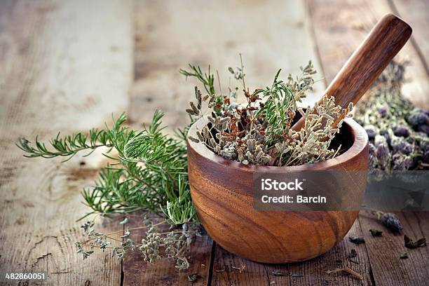 Herbs In Mortar With Pestle On The Table Stock Photo - Download Image Now - Mortar and Pestle, Herbal Medicine, Herb