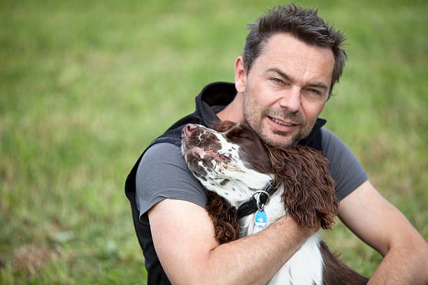 istock Man embracing English Springer Spaniel,close up 482865664