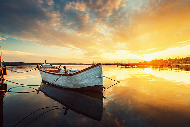 istock Beautiful sunset over calm lake and boat with water reflecting 482869414