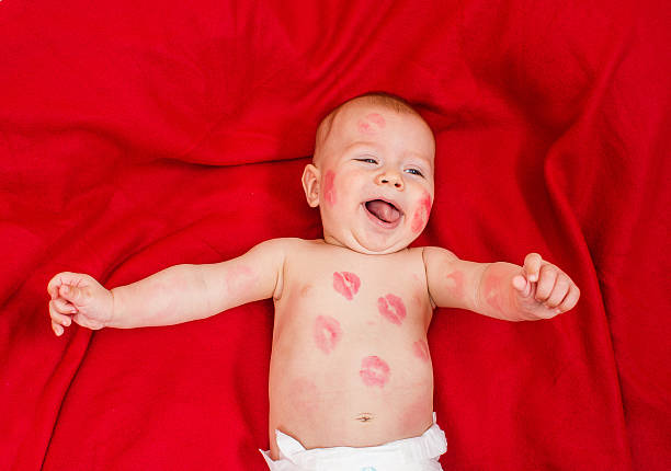 istock cute baby covered with kisses 482872074