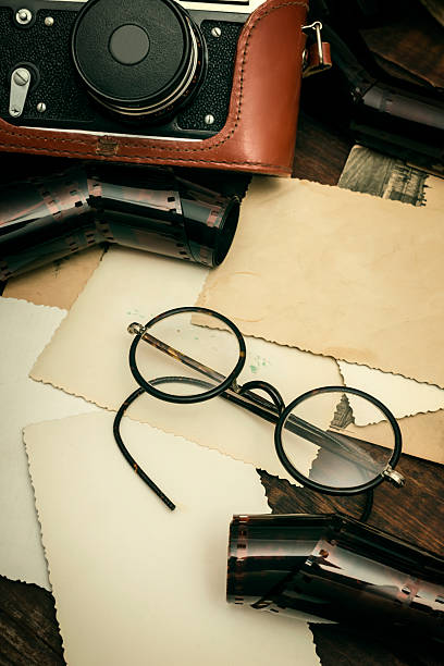 istock retro still camera and some old photos 482875312