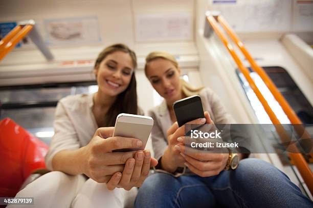 Friends In London Overground Stock Photo - Download Image Now - Mobile Phone, Subway, 20-24 Years