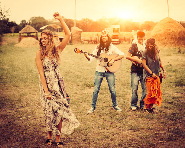 istock Hippie group singing and dancing in a field 482881477
