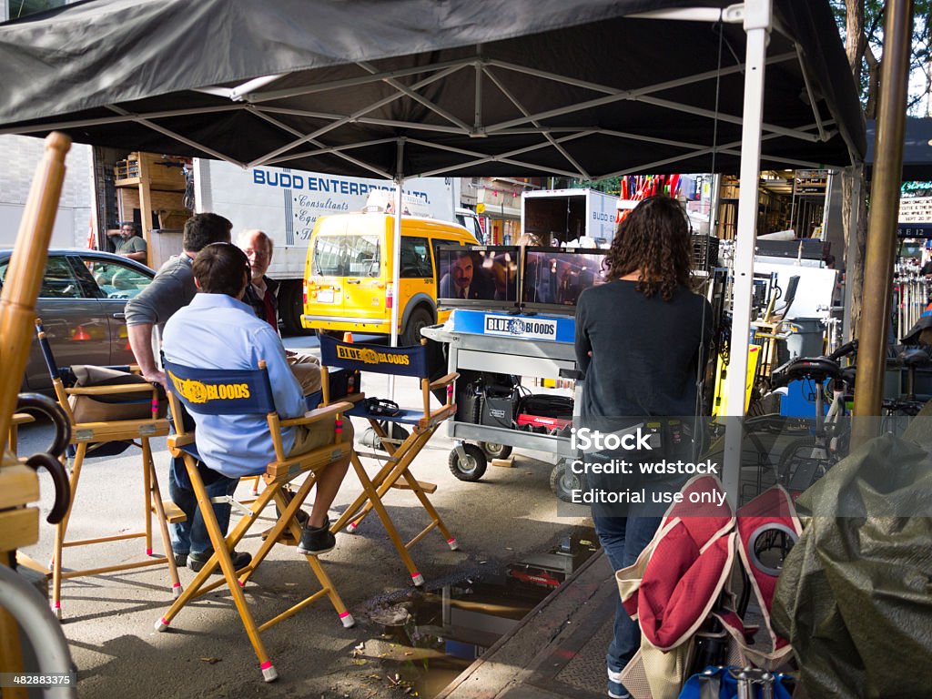 Blue Bloods Location Shoot Manhattan New York, New York, USA - September 19, 2013: TV show personnel monitor an indoor shoot at the Gotham Bar and Grill in Manhattan for the CBS crime drama Blue Bloods. Tom Selleck can be seen on the monitors. Famous Place Stock Photo