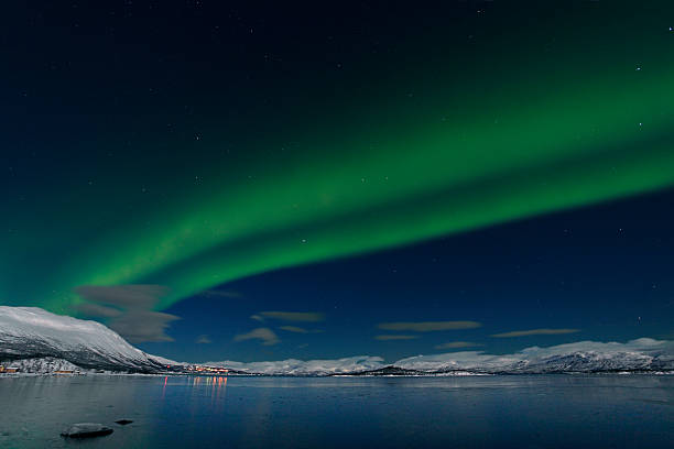 istock Aurora Borealis (Northern Lights) bright over mountains and lake 482884411