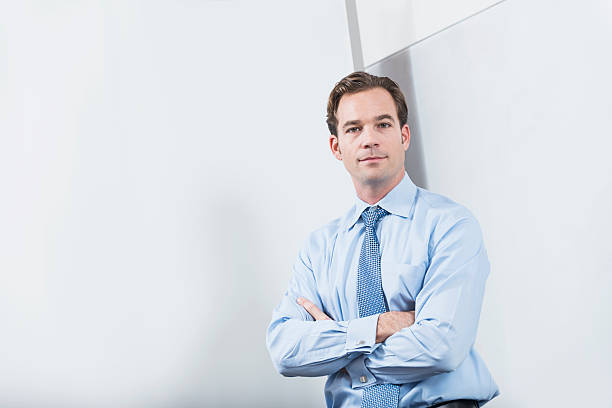 istock Businessman standing by a large blank white board 482887048