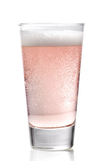 Glass of pink cider on a white background