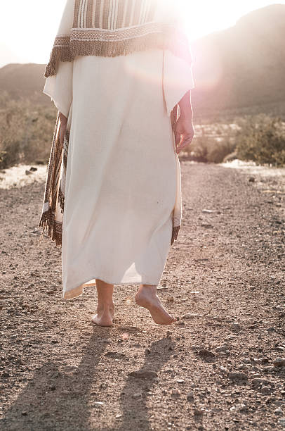 Following Jesus Light radiating from the man representing Jesus as he walks. Similar Images: ceremonial robe stock pictures, royalty-free photos & images