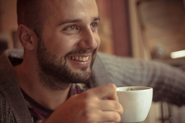 istock Guy looking away holding a cup of coffee 482902017