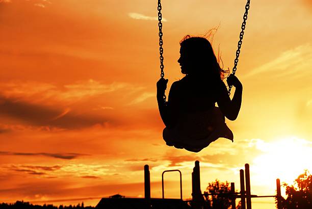 istock Young Girl Swinging at Park 482902523