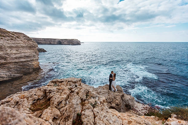 istock Bride and groom near the ocean 482903455