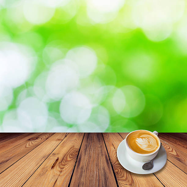Coffee on table with bokeh background in garden