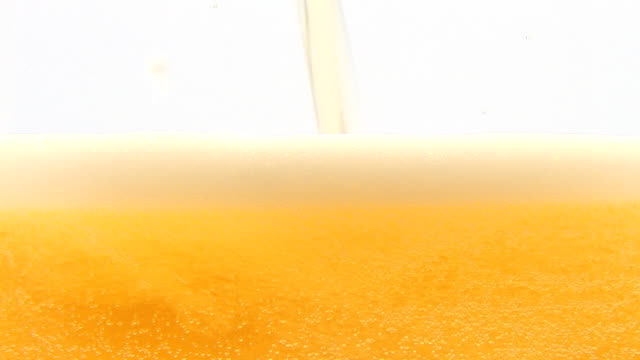 Pouring cold beer into glass