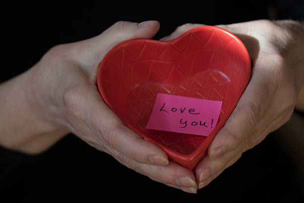 istock Hands holding a heart shaped tray with Love You message 482905855