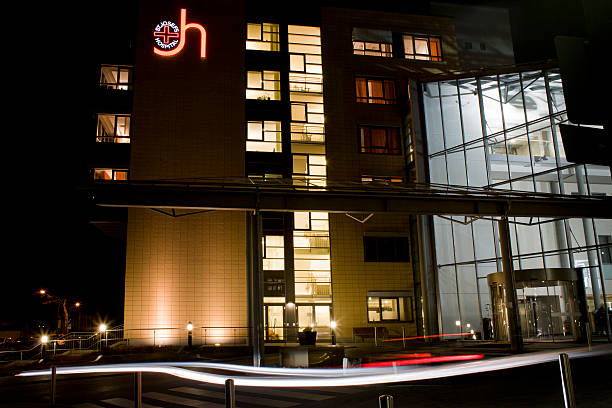 Wiesbaden, Germany - January 30, 2012: Illuminated entrance of St. Josef hospital Wiesbaden, in the foreground blurred motion caused by an arriving car. St. Josef hospital Wiesbaden, also known as JoHo is a general hospital with a capacity of 450 beds in the capital of Hesse - it was founded in 1876 by religious order Arme Dienstmaegde Jesu.