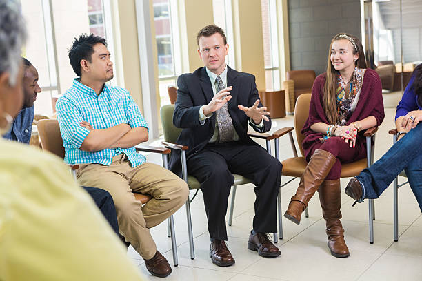 istock A group of seated people are having a discussion. 482907619