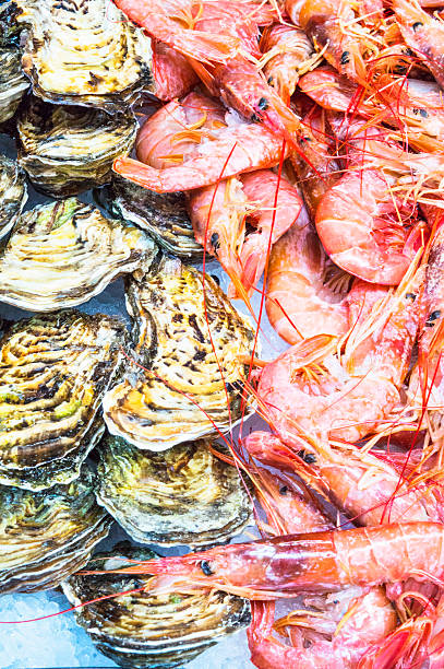 istock Shrimps and oysters on market stall 482907744