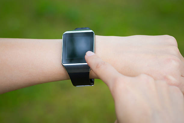 istock Woman holding and touch smart watch. 482908344