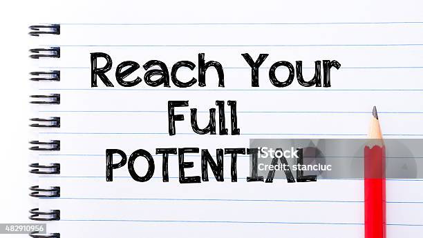 Reach Your Full Potential Text Written On Notebook Page Stock Photo - Download Image Now