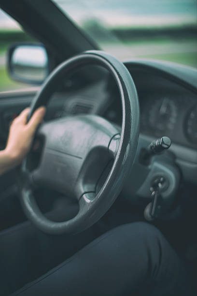 istock Woman's hand driving a car. Unrecognizable person. 482911706