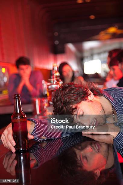 Man Passed Out On Bar In Nightclub Stock Photo - Download Image Now - Addiction, Alcohol - Drink, Bar - Drink Establishment