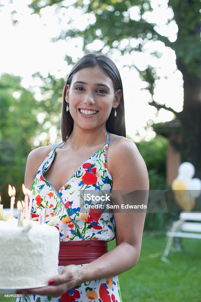 Woman outdoors carrying a birthday cake   Birthday Stock Photo