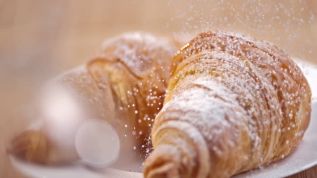 SLO MO Croissants being sprinkled with sugar