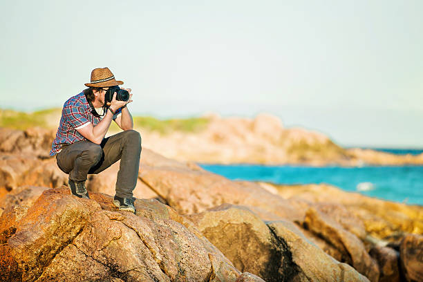 istock Young photographer taking photos at the beach 482914878