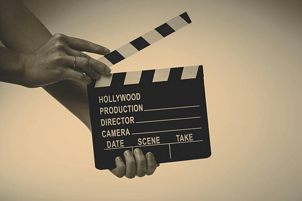 istock Movie flapper in woman hands on white background 482920688