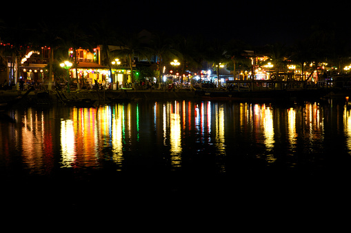 Hoi An, Vietnam - March 15, 2014: Cafe lights reflected on the river of Hoi An ancient town, UNESCO World Heritage Site.