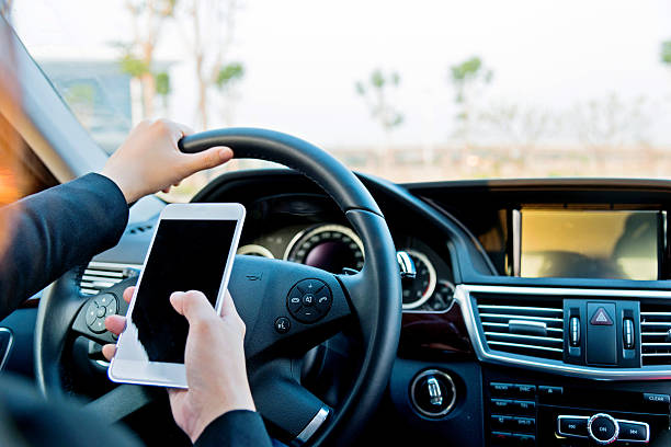 istock businesswoman texting while driving 482921860
