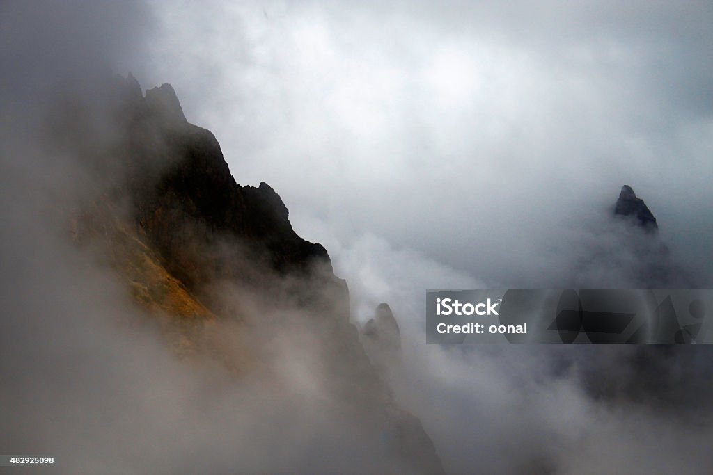 Great mountains disappearing under the strong fogs Great mountains disappearing under the strong fogs  (uploaded upon mutant nature visual trend which is recently declared by Getty Images) 2015 Stock Photo