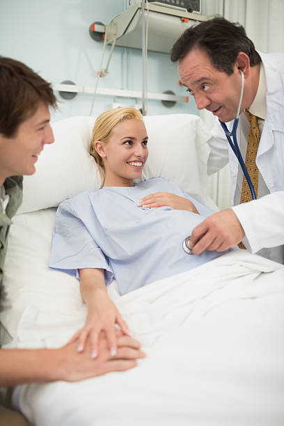 istock Obstetrician using a stethoscope on smiling pregnant woman 482925799