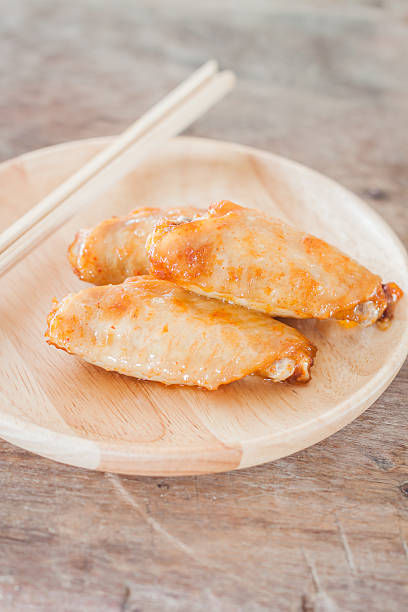 istock Grilled chicken wings on wooden plate 482927700