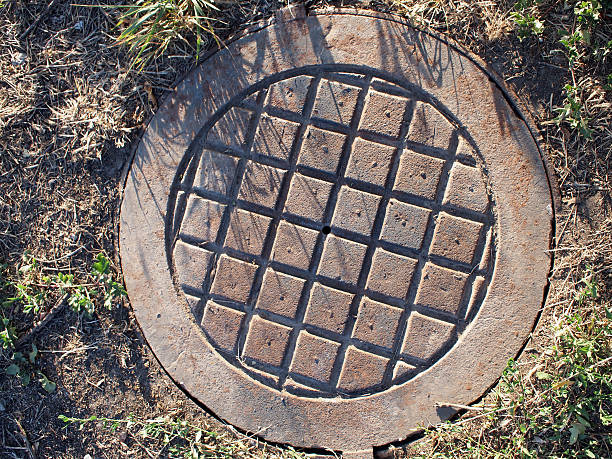 istock Top view of an old and rusty manhole 482928020