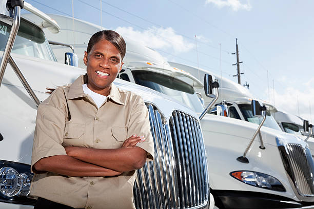istock Female truck driver standing by semi-trucks 482929319