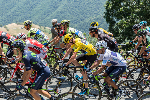 Col D'Aspin,France- July 15,2015: Froome of Team sky, in Yellow Jersey and his main rival Quintana of Movistar Team, in White Jersey, climbing,inside the peloton, the road to Col D'Aspin  in Pyrenees Mountains during the stage 11 of Le Tour de France 2015.