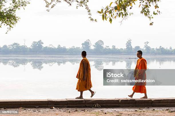Two Monks Walking Along The Lake Pre Rup Templeangkorcambodia Stock Photo - Download Image Now