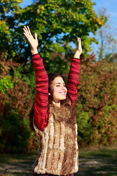 istock Attractive woman with outstretched arms in fall 482939402