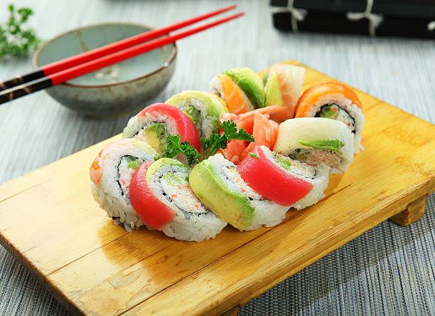 rainbow rolls Japanese sushi, rainbow rolls on wooden cutting board rainbow crab stock pictures, royalty-free photos & images
